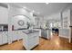 Bright kitchen featuring white cabinetry, granite countertops, brick backsplash, and stainless steel appliances at 4001 Falls River Ave, Raleigh, NC 27614