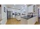 Spacious kitchen with stainless steel appliances, white cabinets, and dark granite countertops at 4001 Falls River Ave, Raleigh, NC 27614