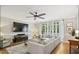 Inviting living room with hardwood floors, large windows, and comfortable seating area at 4001 Falls River Ave, Raleigh, NC 27614
