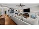 Living room features hardwood floors, ceiling fan, and a large sectional sofa at 4001 Falls River Ave, Raleigh, NC 27614