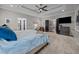 Spacious main bedroom featuring a tray ceiling, ceiling fan, and ensuite bath access at 4001 Falls River Ave, Raleigh, NC 27614