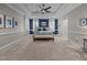 Spacious main bedroom features a decorative tray ceiling, plush carpet, and plenty of space at 4001 Falls River Ave, Raleigh, NC 27614