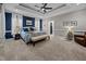 Spacious main bedroom features a decorative tray ceiling, plush carpet, and plenty of space at 4001 Falls River Ave, Raleigh, NC 27614