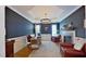 Elegant home office with tray ceiling, modern lighting, a fireplace and neutral color palette at 4001 Falls River Ave, Raleigh, NC 27614