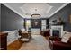 Home office with decorative fireplace and leather sitting chairs at 4001 Falls River Ave, Raleigh, NC 27614