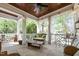 Relaxing porch with comfortable seating, wooden ceiling, and sheer curtains for privacy at 4001 Falls River Ave, Raleigh, NC 27614