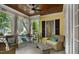 Charming covered porch with comfortable seating and ceiling fan at 4001 Falls River Ave, Raleigh, NC 27614