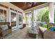 Covered porch with comfortable wicker seating, string lights, wood ceiling, and a relaxing outdoor ambiance at 4001 Falls River Ave, Raleigh, NC 27614