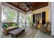 Relaxing screened-in porch featuring wicker furniture, ceiling fan, and wood ceiling at 4001 Falls River Ave, Raleigh, NC 27614