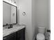 Bathroom featuring modern fixtures, dark vanity, and a stylish design at 412 Hay River St, Garner, NC 27529