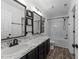 Elegant bathroom featuring modern vanity, marbled countertop, and a shower-tub combo at 412 Hay River St, Garner, NC 27529