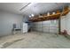Spacious garage offering ample storage with overhead shelving and additional space for parking at 412 Hay River St, Garner, NC 27529