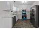 Stylish kitchen featuring stainless steel appliances, white cabinetry, and a modern design at 412 Hay River St, Garner, NC 27529