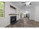 Open-concept living room with fireplace, hardwood floors and lots of light at 412 Hay River St, Garner, NC 27529