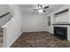 Cozy living room featuring wood-look floors, fireplace, and abundant natural light at 412 Hay River St, Garner, NC 27529