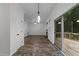 Open living room area featuring a sliding door, recessed lighting, and wood-look flooring at 412 Hay River St, Garner, NC 27529