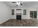 Bright living room featuring a fireplace, wood-look flooring, and sliding glass doors to the deck at 412 Hay River St, Garner, NC 27529