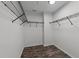 Functional walk-in closet with dark wood-look flooring and metal shelving for efficient storage at 412 Hay River St, Garner, NC 27529