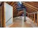 Unfinished attic space offers potential for storage or custom build-out with exposed wooden beams at 417 N Gurney St, Burlington, NC 27215