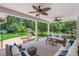 Covered back porch with comfortable seating, ceiling fans, and views of the backyard at 417 N Gurney St, Burlington, NC 27215