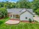 Wonderful backyard view features a patio, well-manicured lawn, and mature trees offering privacy at 417 N Gurney St, Burlington, NC 27215