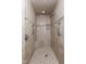 Shower with neutral colored tiles, built-in shelves, and chrome shower fixtures at 417 N Gurney St, Burlington, NC 27215
