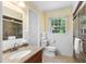 Bright bathroom featuring granite countertop, tiled floors, and a shower with glass doors at 417 N Gurney St, Burlington, NC 27215