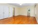 Bedroom with hardwood floors, a ceiling light, and a view to an adjoining room with a bathroom at 417 N Gurney St, Burlington, NC 27215