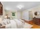 Serene bedroom with hardwood floors, neutral decor, and a cozy sitting area at 417 N Gurney St, Burlington, NC 27215