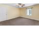 Neutral bedroom with carpet, a ceiling fan, a window, and white trim at 417 N Gurney St, Burlington, NC 27215