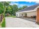 The carport area features a spacious driveway, and lush yard with a shed at 417 N Gurney St, Burlington, NC 27215