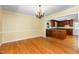 Dining room with hardwood floors leading to a kitchen with granite countertops at 417 N Gurney St, Burlington, NC 27215