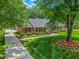 Lovely brick home with lush lawn, mature trees, and a long driveway leading to the residence at 417 N Gurney St, Burlington, NC 27215