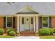 Welcoming front entrance features brick steps, white columns, and decorative door details at 417 N Gurney St, Burlington, NC 27215
