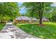 Charming brick home with manicured lawn, mature tree and inviting curb appeal at 417 N Gurney St, Burlington, NC 27215