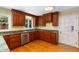Well-lit kitchen boasts granite countertops, stainless steel appliances, and wooden cabinetry at 417 N Gurney St, Burlington, NC 27215