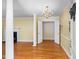 Spacious living room with hardwood floors, columns, chandelier, and fireplace at 417 N Gurney St, Burlington, NC 27215