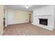 View of the living room showcasing the white brick fireplace, neutral carpet, and white trim at 417 N Gurney St, Burlington, NC 27215