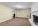 Bright living room with a white brick fireplace, neutral carpet and a view into an adjoining room at 417 N Gurney St, Burlington, NC 27215