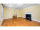 Bright living room features hardwood floors, fireplace, and elegant chandelier at 417 N Gurney St, Burlington, NC 27215