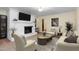Cozy living room featuring a white brick fireplace, comfortable seating, and ample lighting at 417 N Gurney St, Burlington, NC 27215