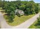 An aerial view of the residence shows the home's placement on a tree-lined corner lot at 44 Supreme Dr, Lillington, NC 27546
