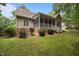 Charming home featuring a screened-in porch, brick foundation, and landscaped yard at 44 Supreme Dr, Lillington, NC 27546