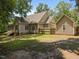 The home features a spacious backyard with a fenced-in area, detached garage, and mature trees at 44 Supreme Dr, Lillington, NC 27546