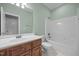 Bathroom features a wood vanity, single sink and a tub with shower at 44 Supreme Dr, Lillington, NC 27546
