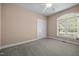 Bedroom features neutral walls, carpet flooring, a ceiling fan, and a window providing natural light at 44 Supreme Dr, Lillington, NC 27546