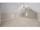 Large bonus room featuring neutral paint, plush carpeting, storage access, and a ceiling fan at 44 Supreme Dr, Lillington, NC 27546