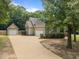 Exterior showcasing the home, detached garage, and long driveway at 44 Supreme Dr, Lillington, NC 27546