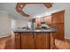 Beautiful kitchen island featuring wooden cabinets, dark countertops and stainless appliances, offering ample storage and workspace at 44 Supreme Dr, Lillington, NC 27546
