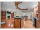 Open kitchen with an island, stainless steel appliances, granite countertops and hardwood floors with recessed lighting at 44 Supreme Dr, Lillington, NC 27546